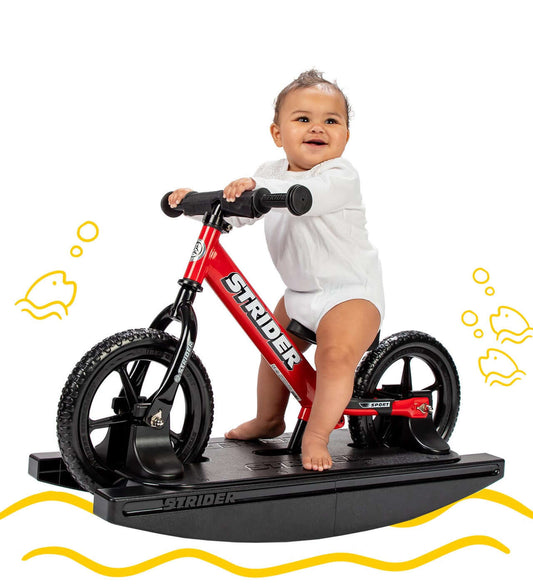 Baby enjoying the Strider Sport 2-in-1 Rocking Bike, learning to balance on a rocking base.
