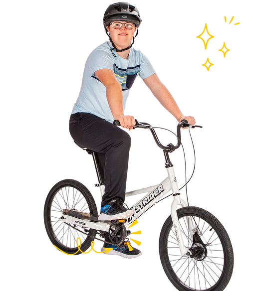 Child riding Strider 20x Sport Bike with pedals, wearing helmet, promoting confidence in learning to ride for ages 8 and up.