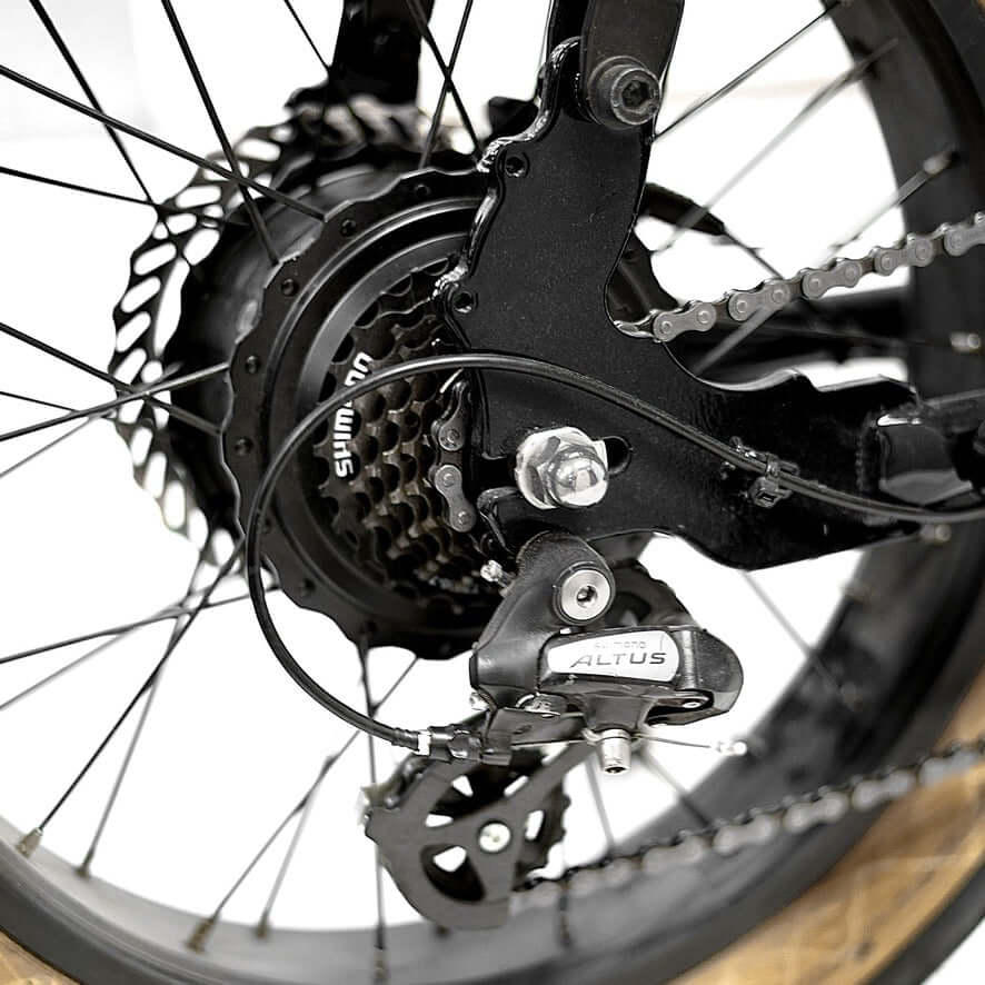 Close-up of the rear hub motor and Shimano Altus derailleur on a Golden Cycles Panthro electric bike.