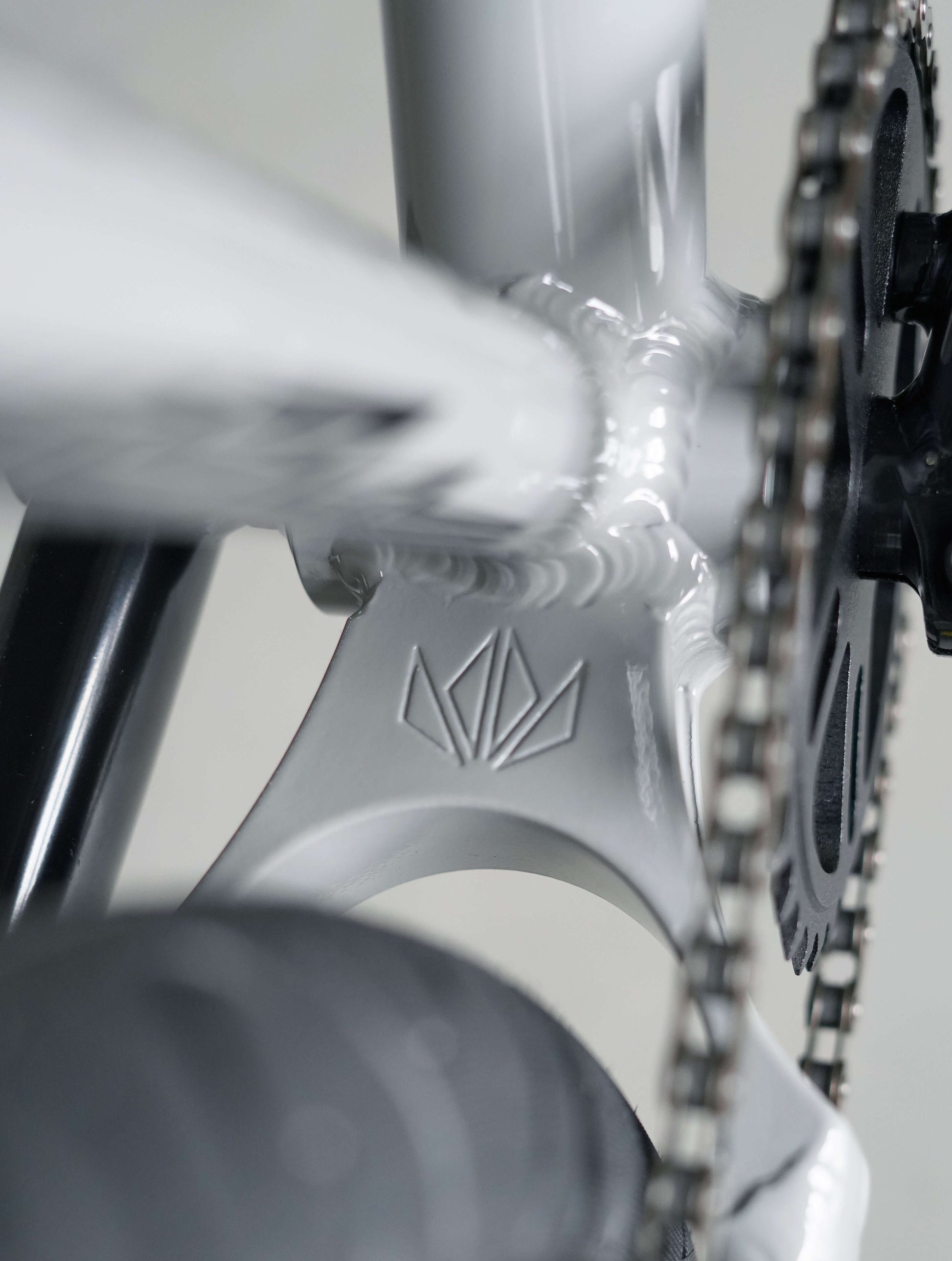 Close-up of Throne Goon 29" BMX bike's welded big yolk and chainring, showcasing strong construction and design.