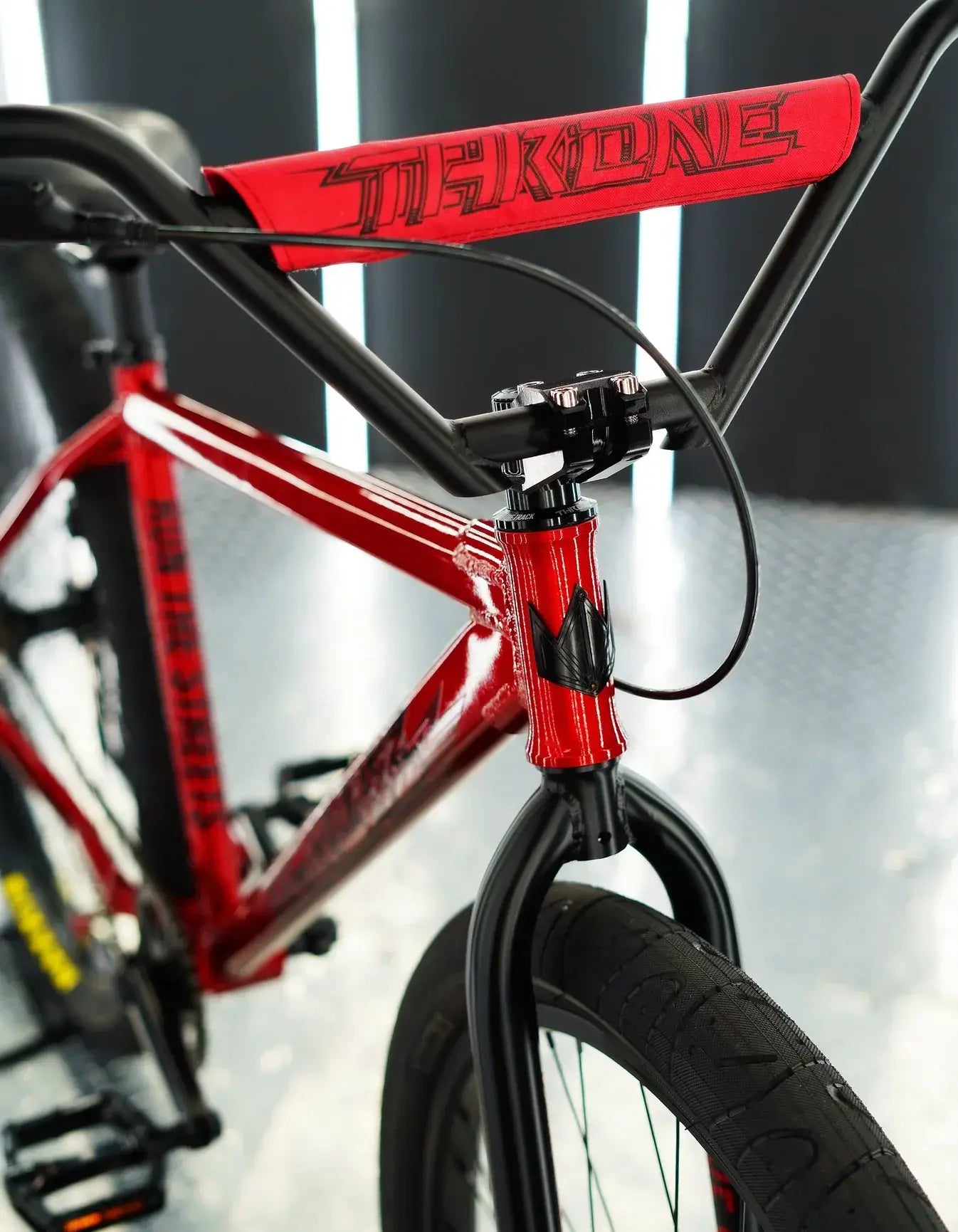 Close-up of the Throne Goon 29" BMX bike showing the red handlebars and welded frame details.