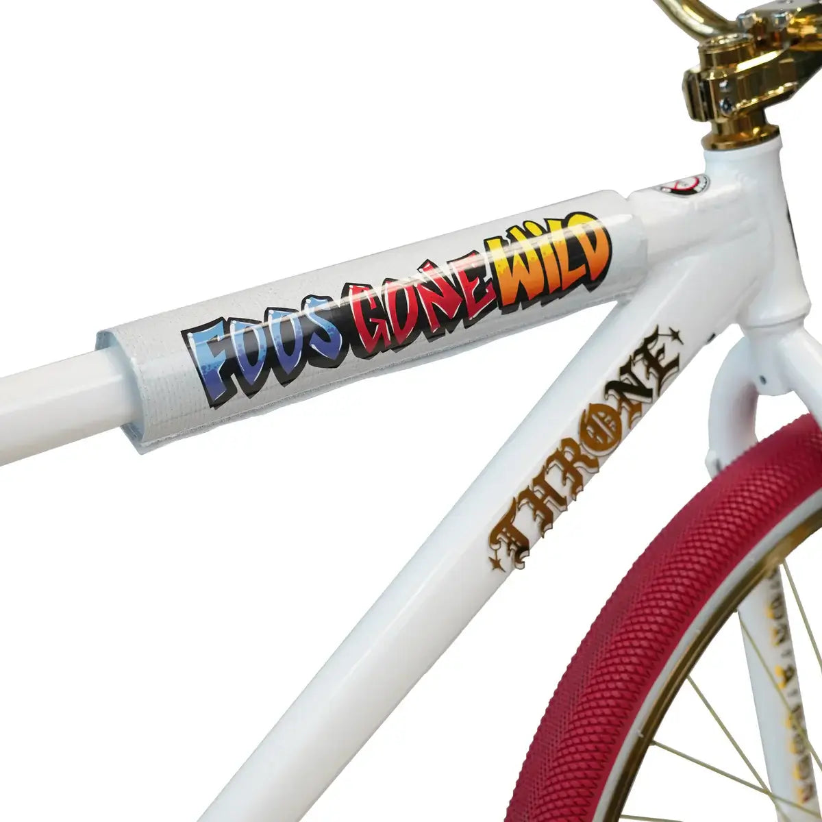 Close-up of Throne BMX bike frame with 'FOOS GONE WILD' graphic and pink tires, showcasing stylish design and upgrades.