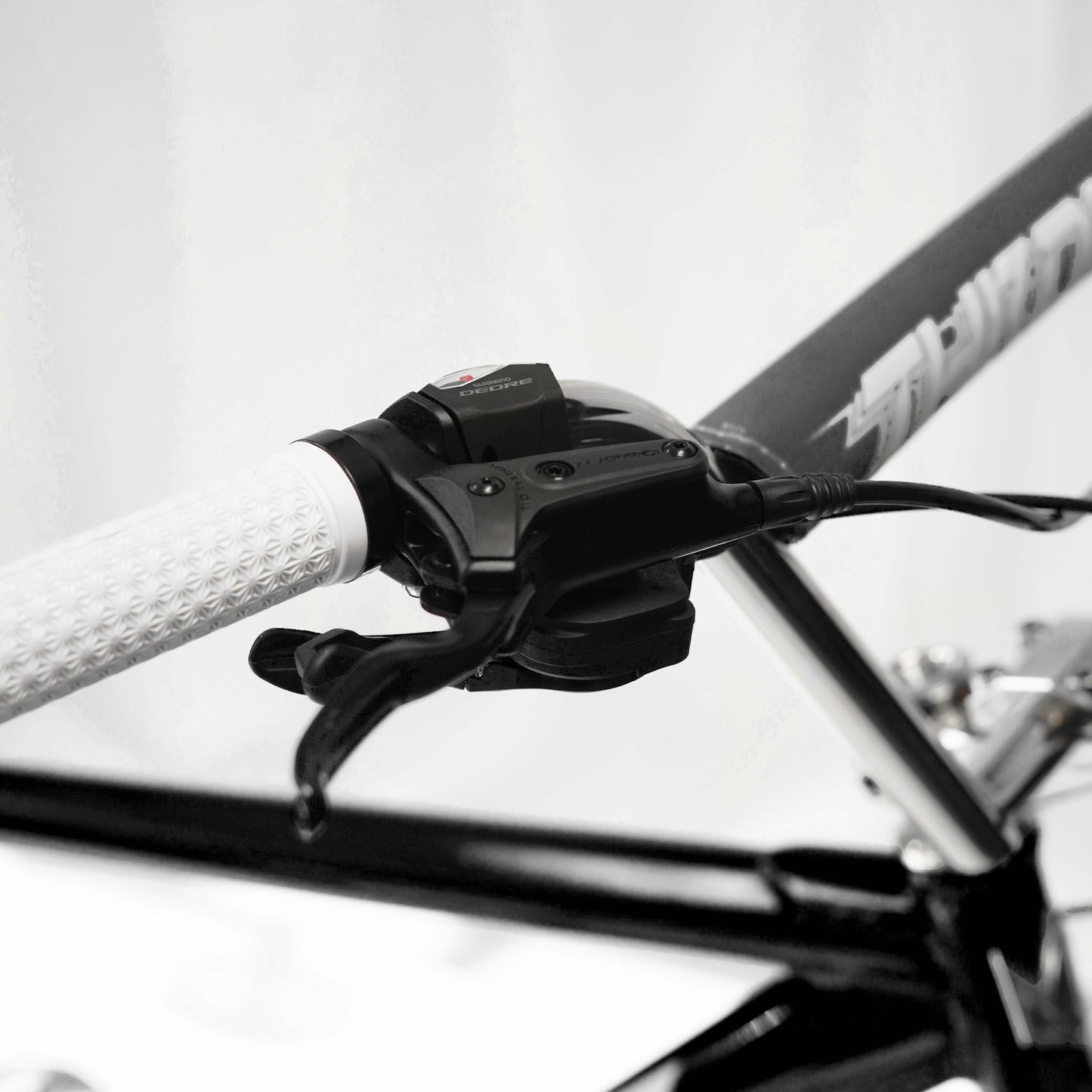 Close-up of the 10-speed shifter and hydraulic brake controls on the Throne Goon Runner BMX bike.