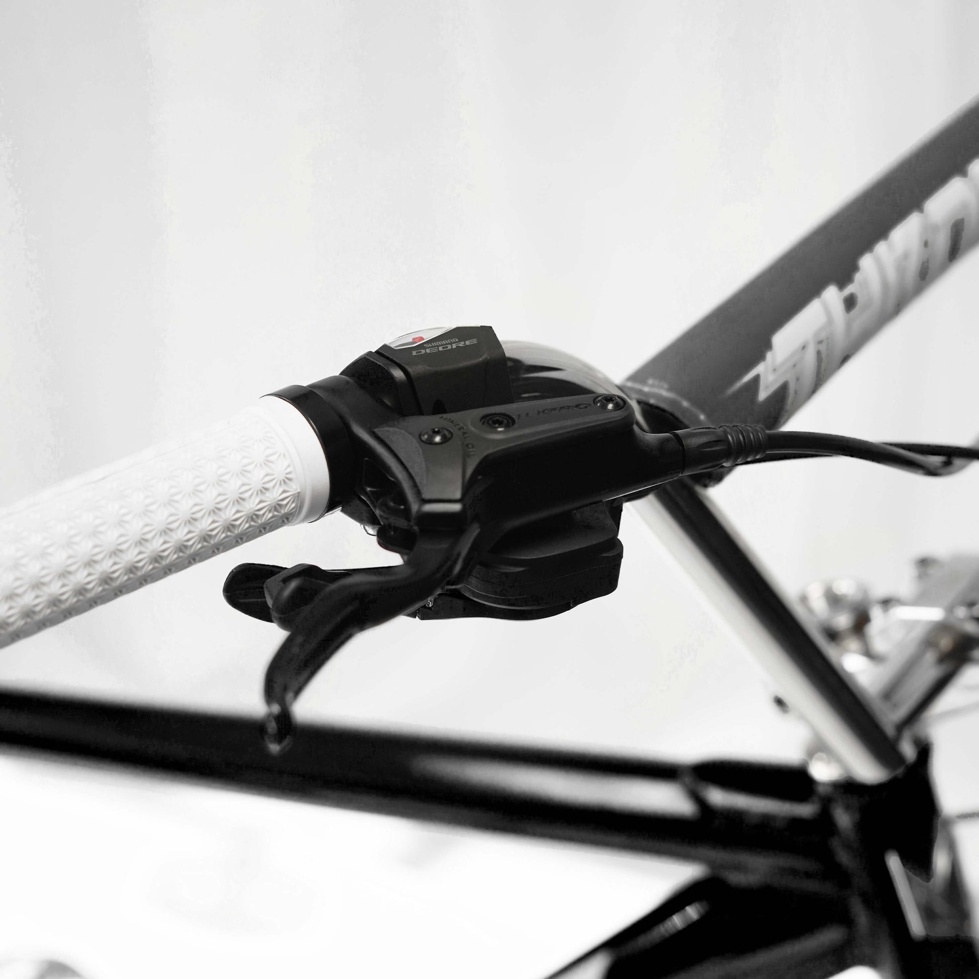 Close-up of the 10-speed shifter and hydraulic brake controls on the Throne Goon Runner BMX bike.