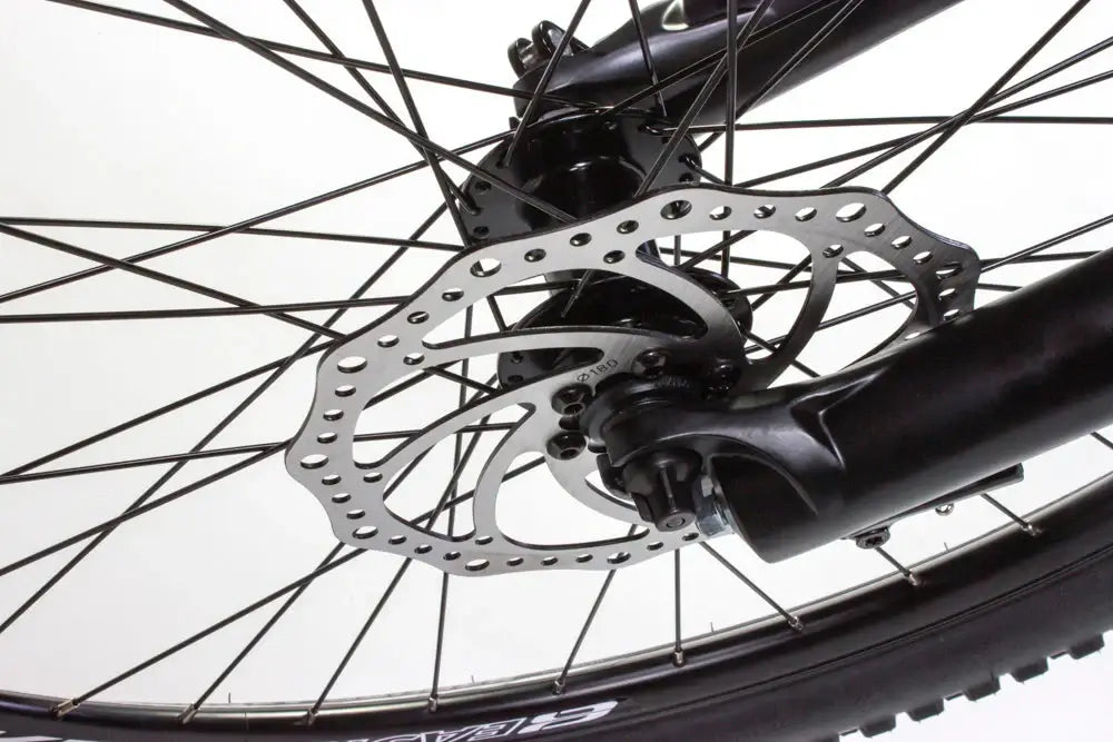 Close-up of hydraulic disc brake on Eastern Bike Alpaka 27.5" for improved control and stopping power.