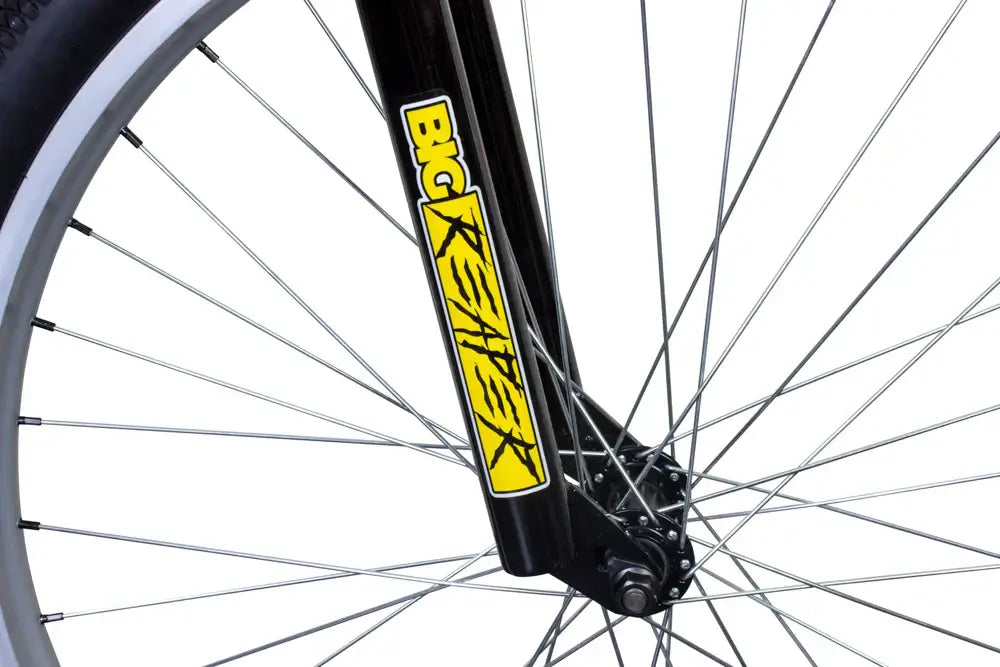 Close-up of Eastern Bike Big Reaper LTD front fork with yellow logo, showcasing its street performance features.