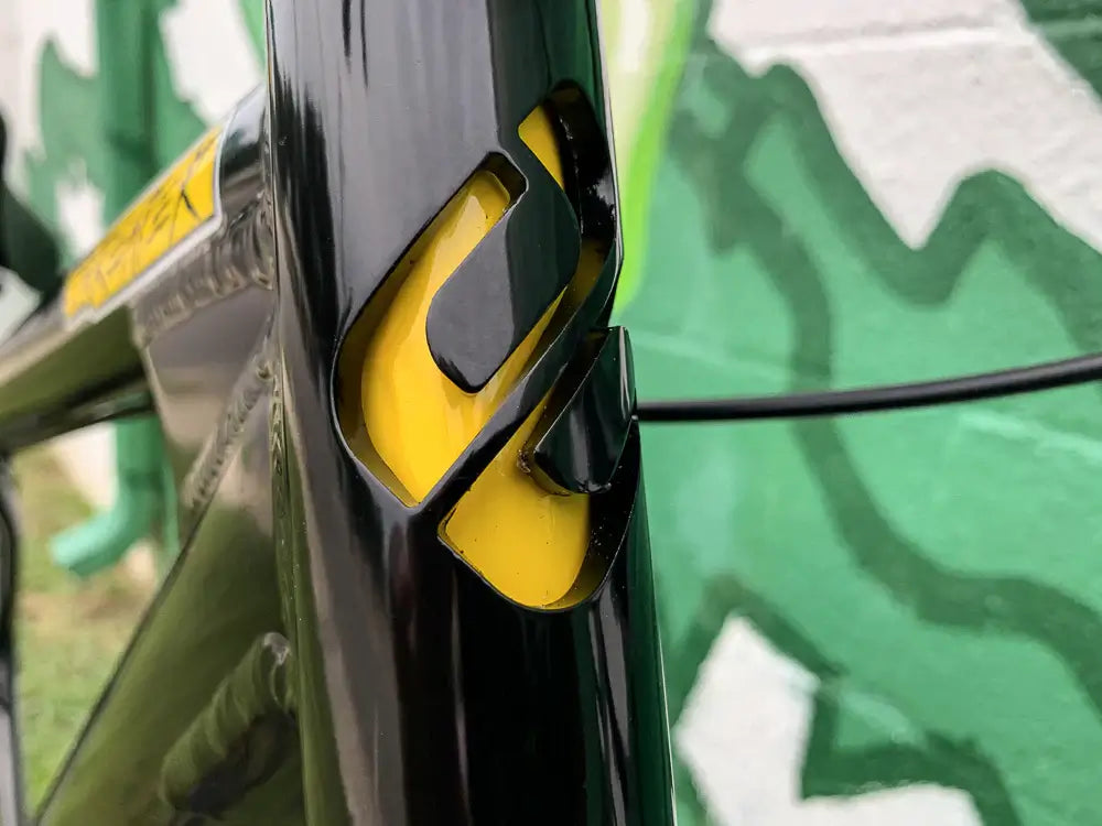 Close-up of the Eastern Bike Big Reaper LTD frame showcasing the sleek black and yellow design detail.