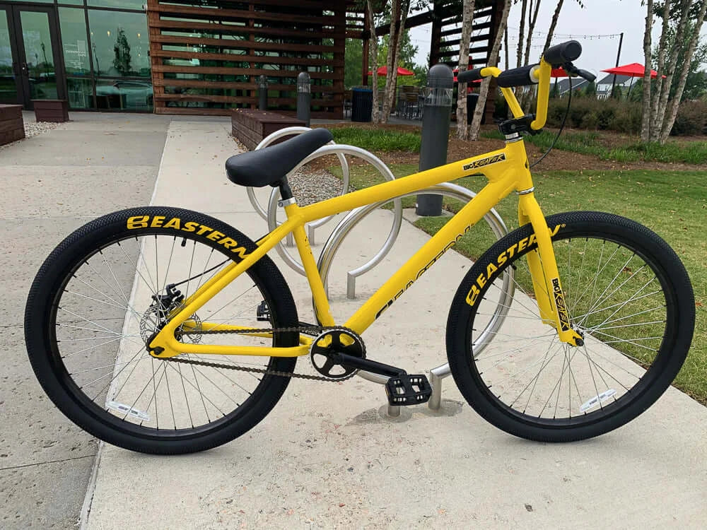 Eastern Bike Big Reaper LTD in vibrant yellow with black wheels, featuring logo tires and a sturdy frame for street riding.