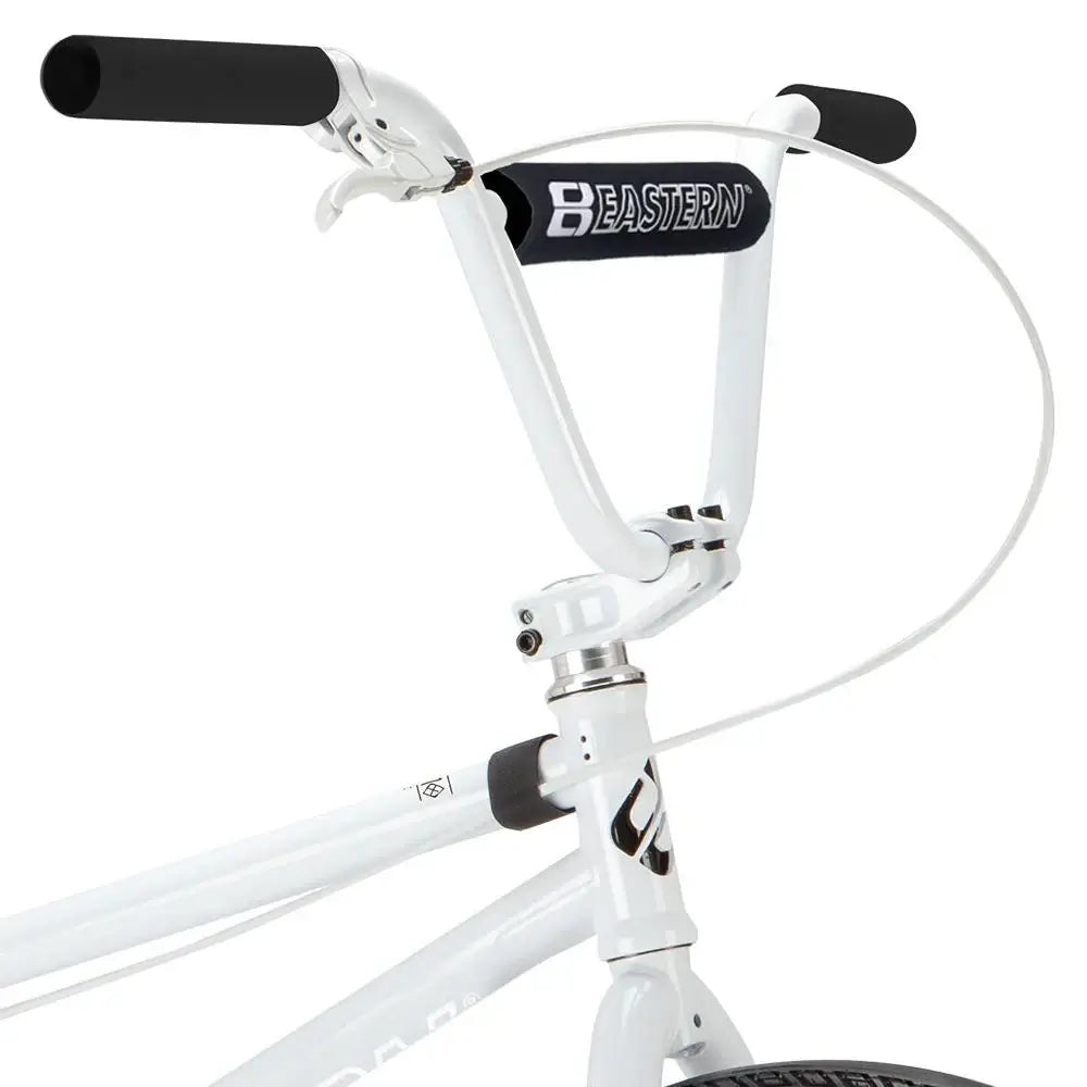Close-up of Eastern Bike Element handlebars with black grips and logo, showcasing the bike's sleek design.