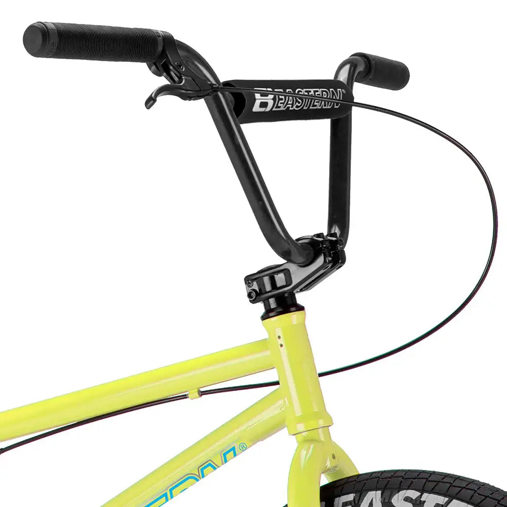 Close-up of the Eastern Javelin bike's handlebars showcasing the black BMX handlebars and yellow frame.