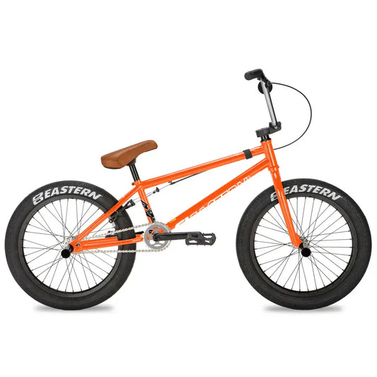Eastern Shovelhead bike in vibrant orange with chromoly frame, wide tires, and sleek design for expert performance.
