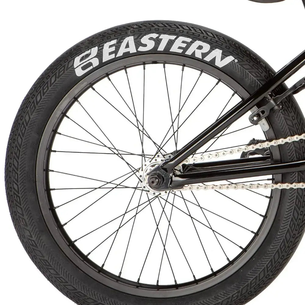 Close-up of Eastern bike wheel with Squealer tire and black spokes, showcasing quality construction and design.