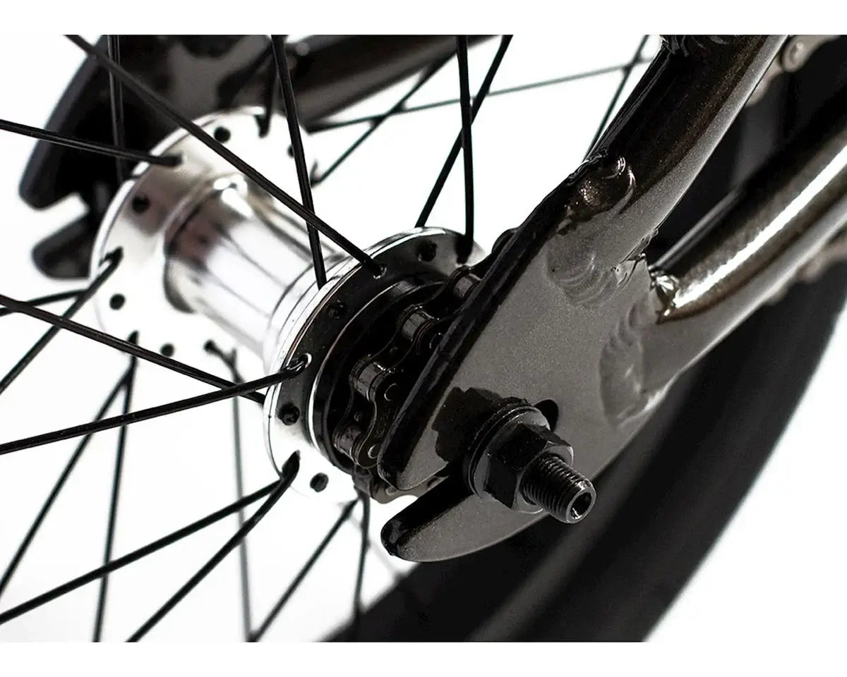 Close-up of a BMX bike wheel hub showing spokes and metallic components for durability and performance.