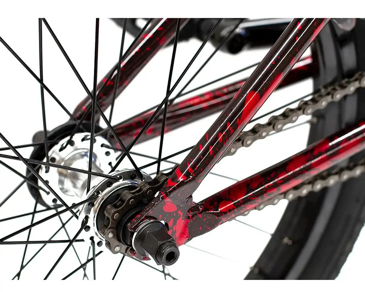 Close-up of the rear hub and chain of a Colony Premise 20" BMX bike with a red and black paint job.