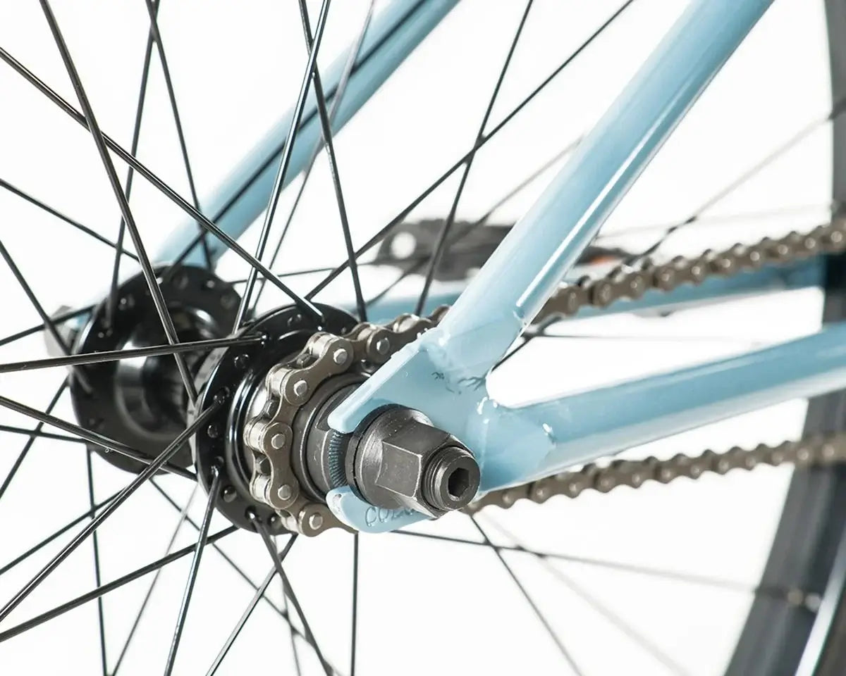 Close-up of the rear hub, chain, and chromoly frame of the Colony Eclipse 26" BMX bike.