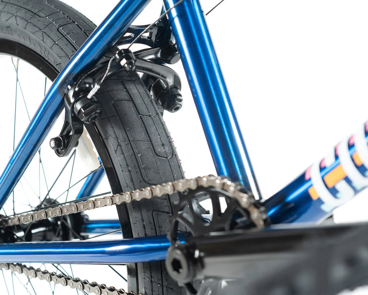 Close-up of Colony Premise BMX bike showcasing the blue frame, tire, and chain details.