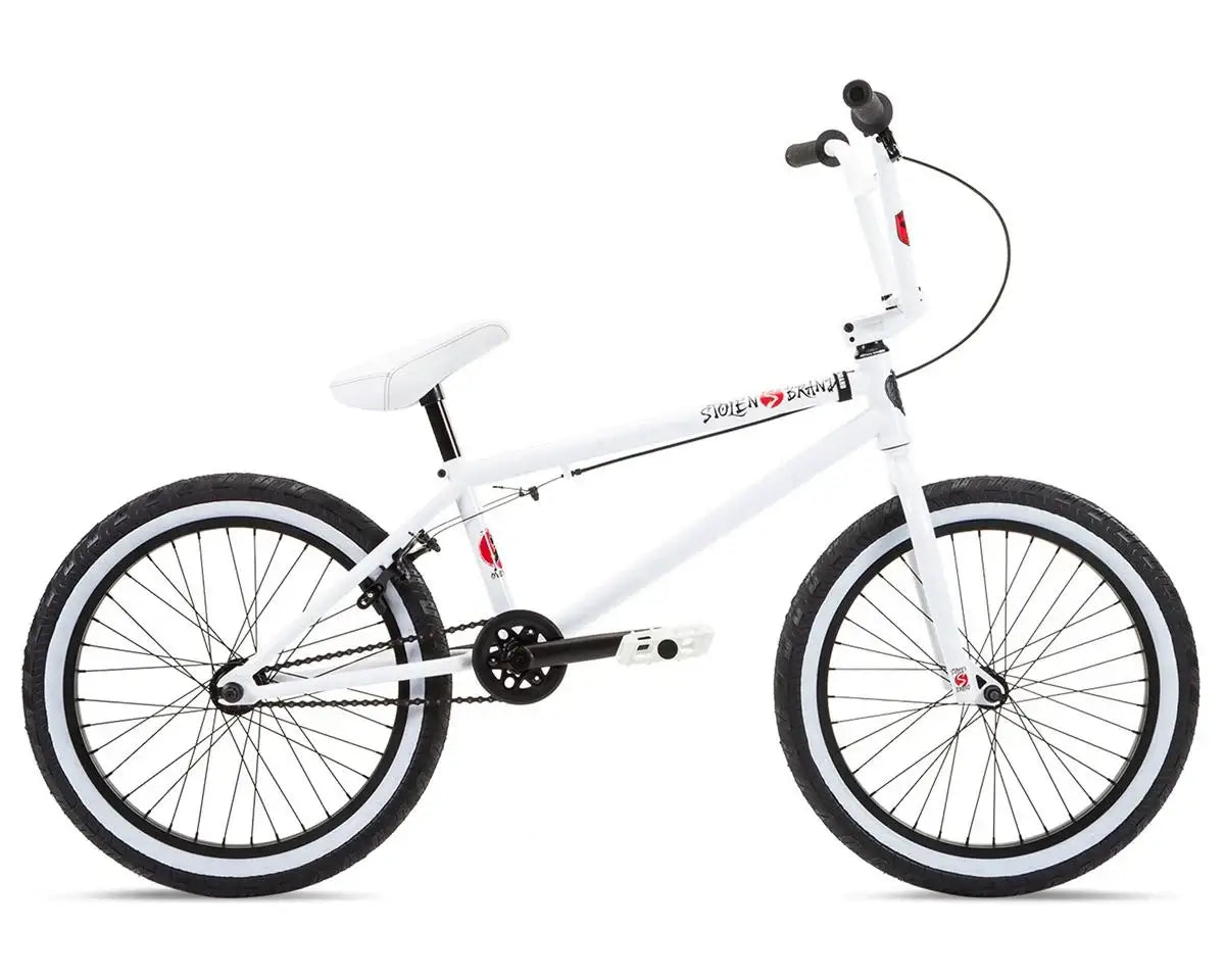 Stolen Overlord 20" BMX bike in white with black tires, featuring high-tensile steel frame and sealed bearings.