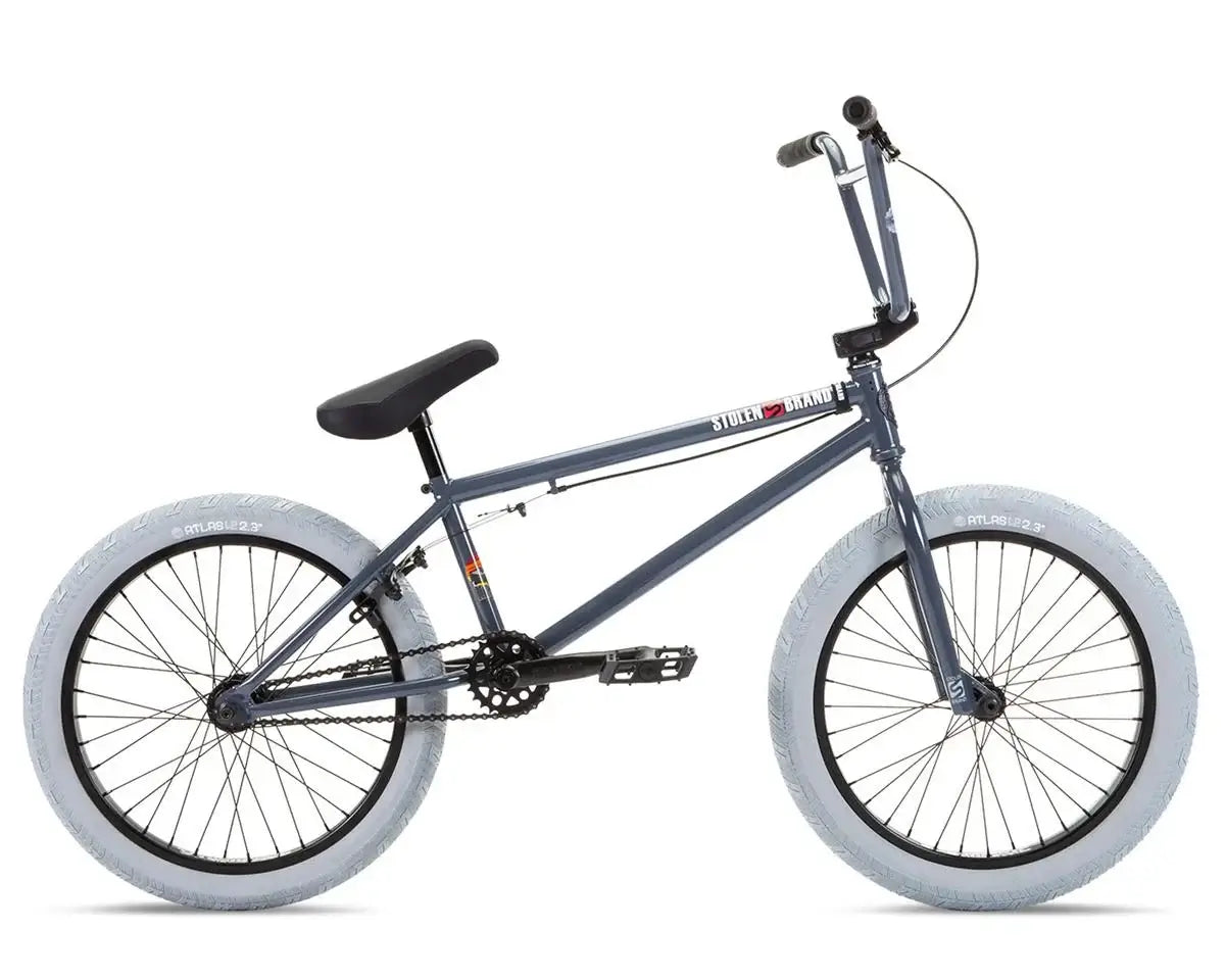 Stolen Heist 20" BMX bike in gray with white tires, featuring durable chromoly frame and aftermarket parts.