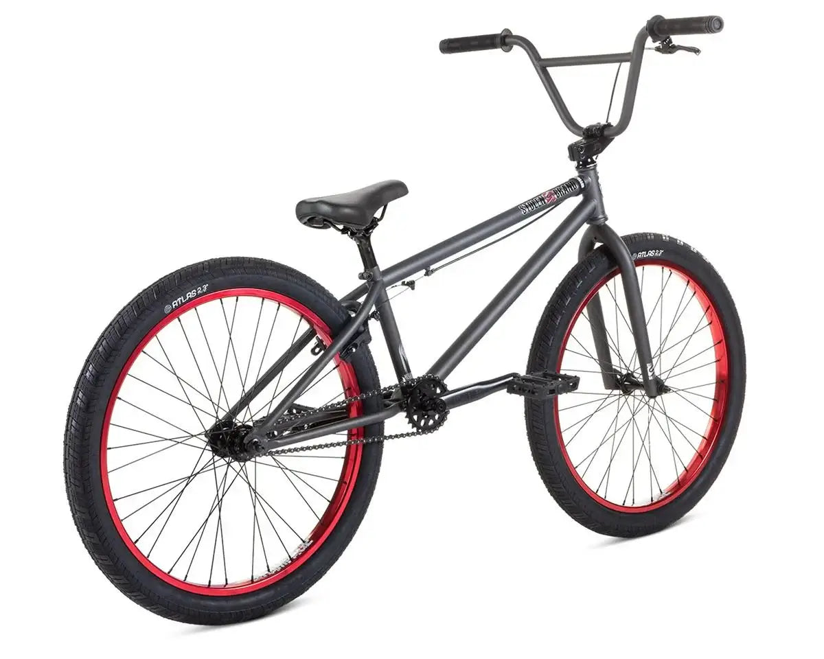 Stolen Saint 24" BMX bike with a full chromoly frame and red rims, designed for smooth cruising and BMX riding.
