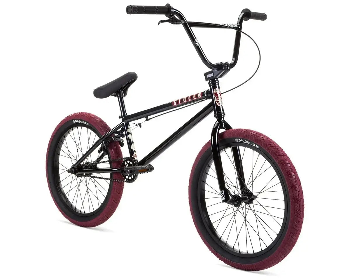 Stolen Casino 20" BMX Bike with black frame and burgundy tires in a dynamic angle.