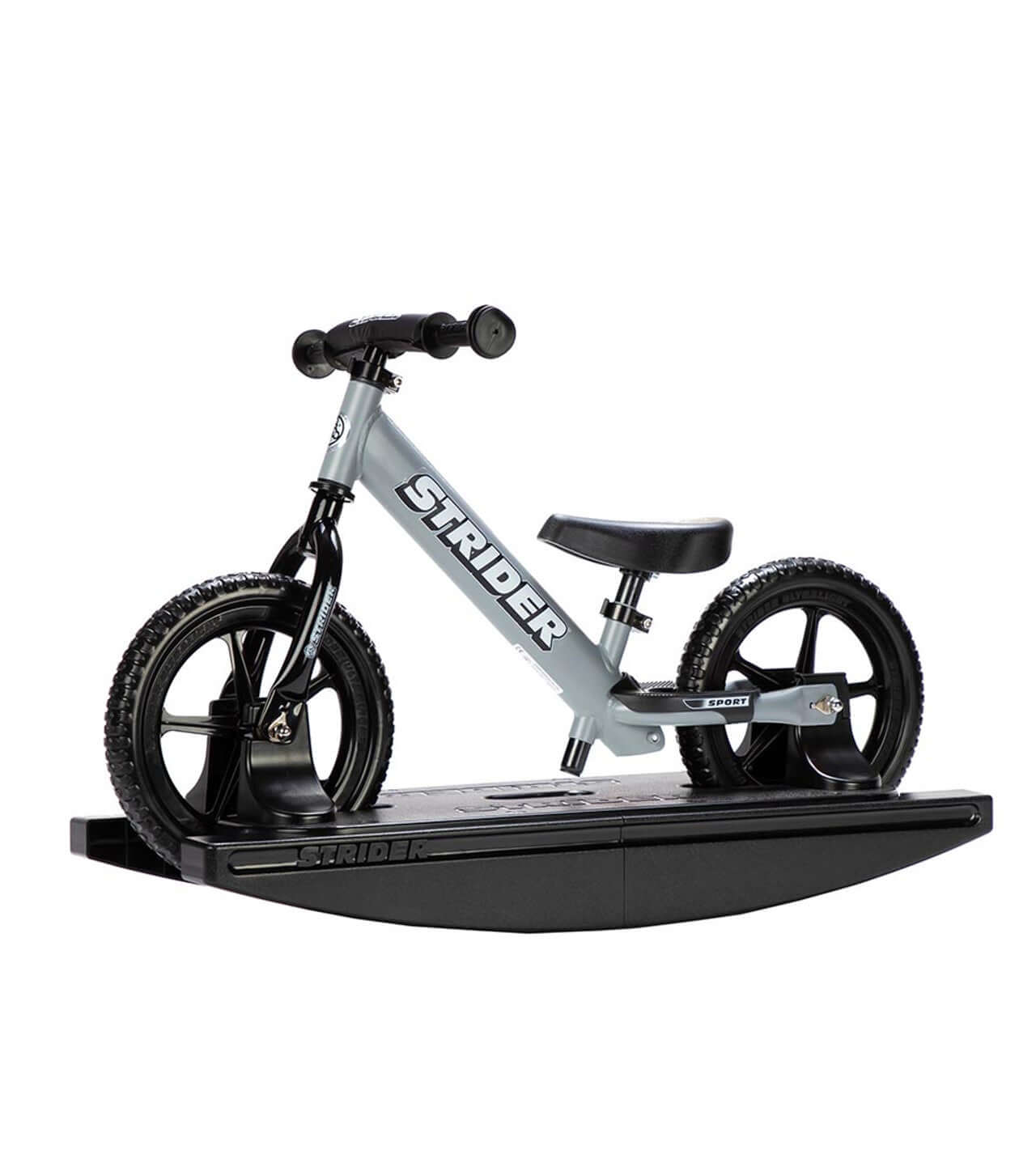 Strider Sport 2-in-1 Rocking Bike on a black rocking base, ideal for teaching babies balance and bonding with their first bike.