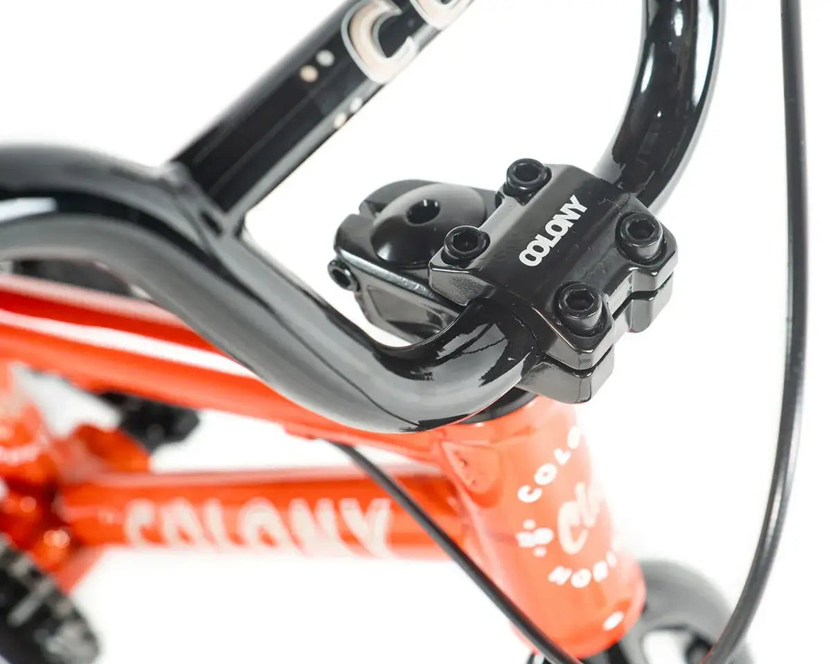Close-up of Colony BMX bike handlebars and stem, showcasing lightweight design and sleek black finish.