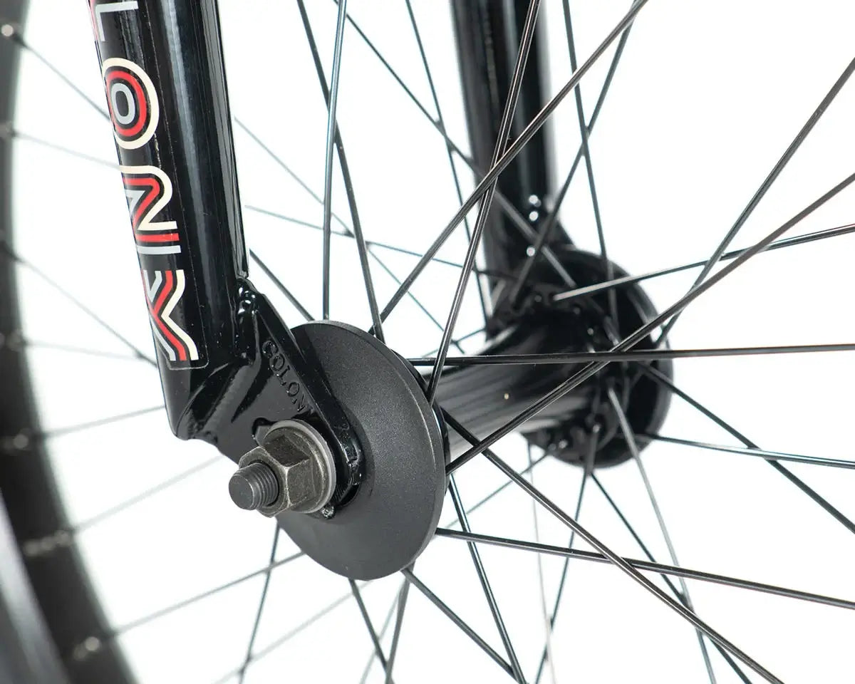 Close-up of Colony Emerge BMX bike fork and wheel hub, showcasing durable spokes and design details.