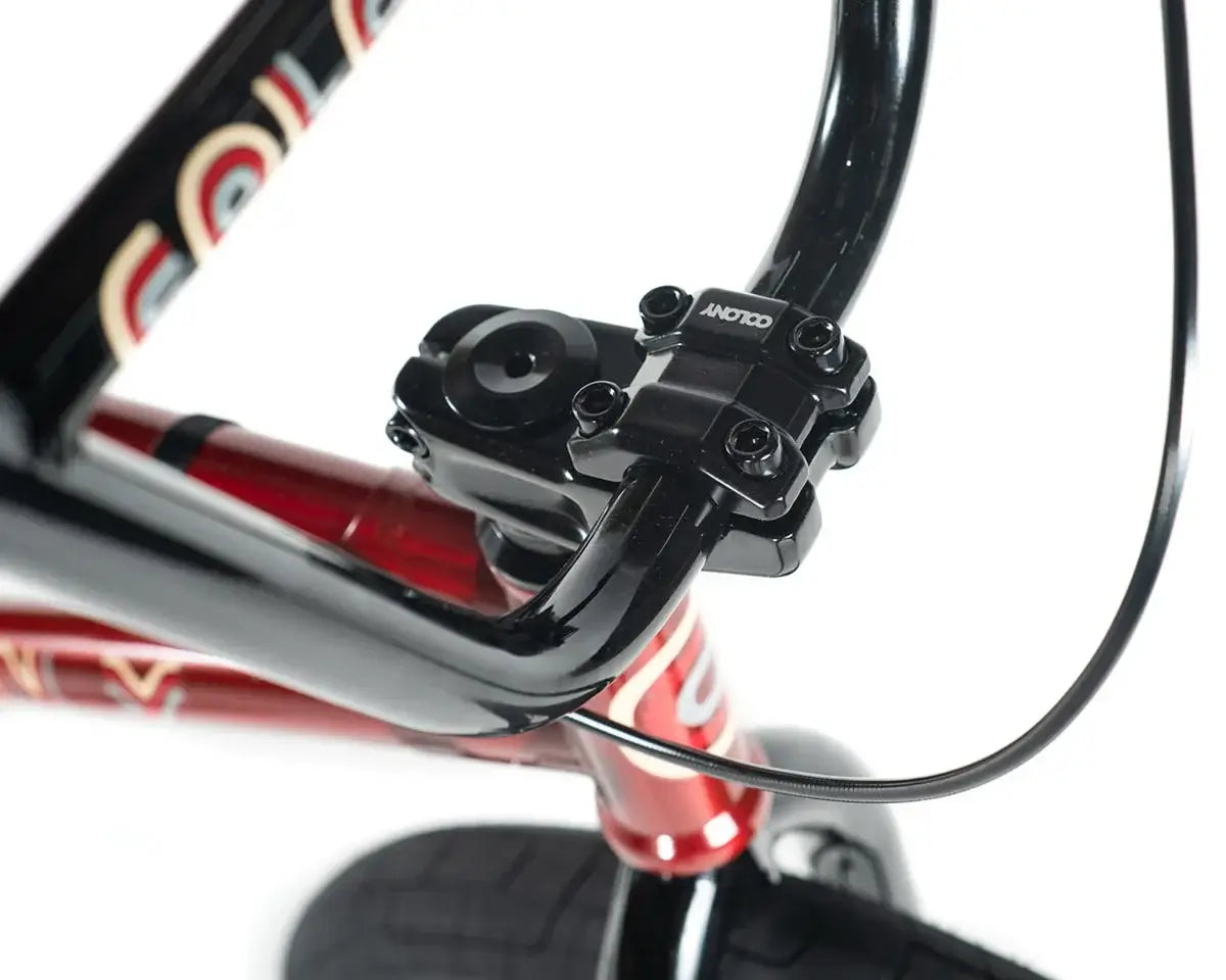 Close-up of Colony Emerge BMX bike handlebars and stem, showcasing black details and chromoly frame design.