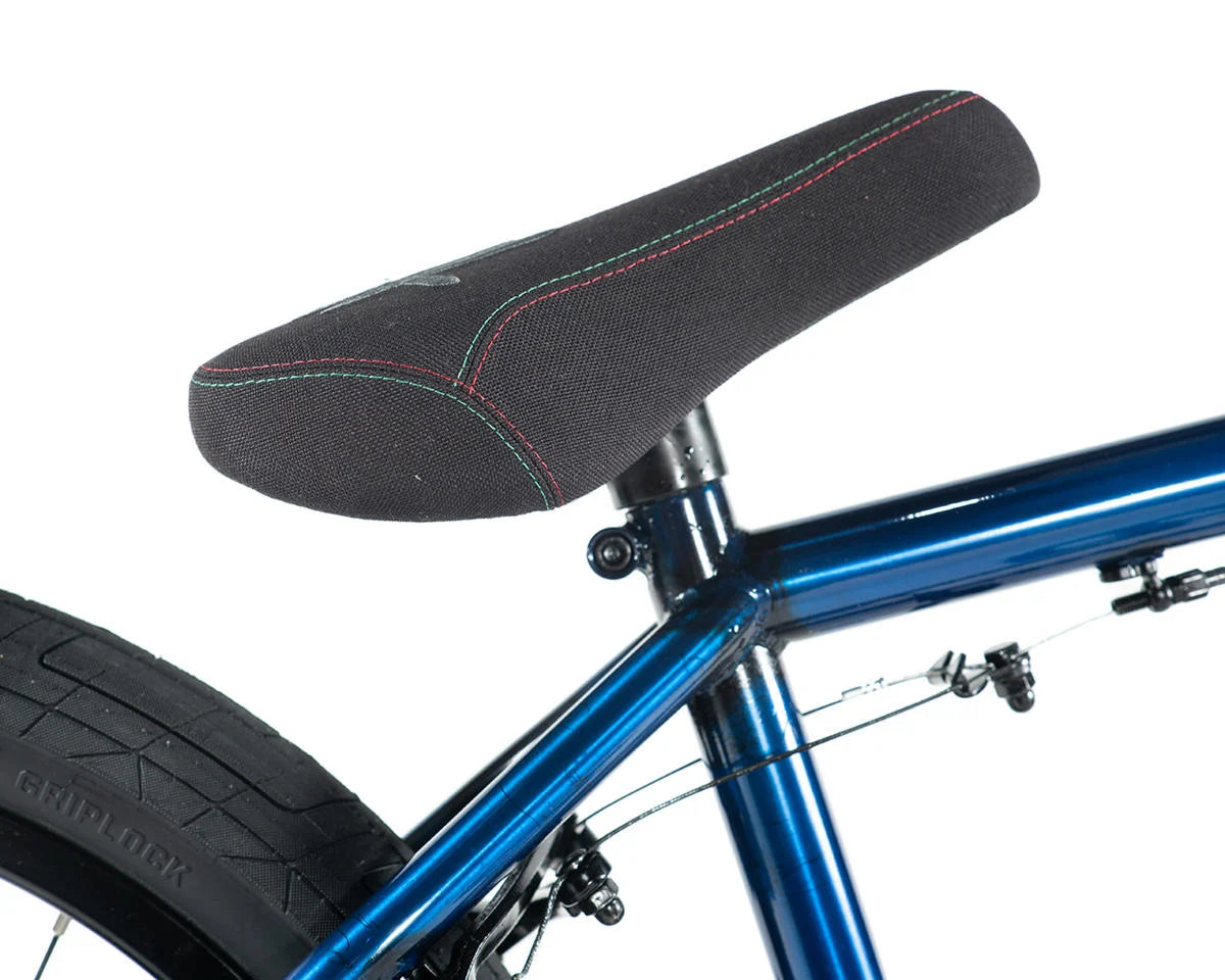 Close-up of the Colony Premise BMX bike saddle showing its black fabric with colorful stitching.
