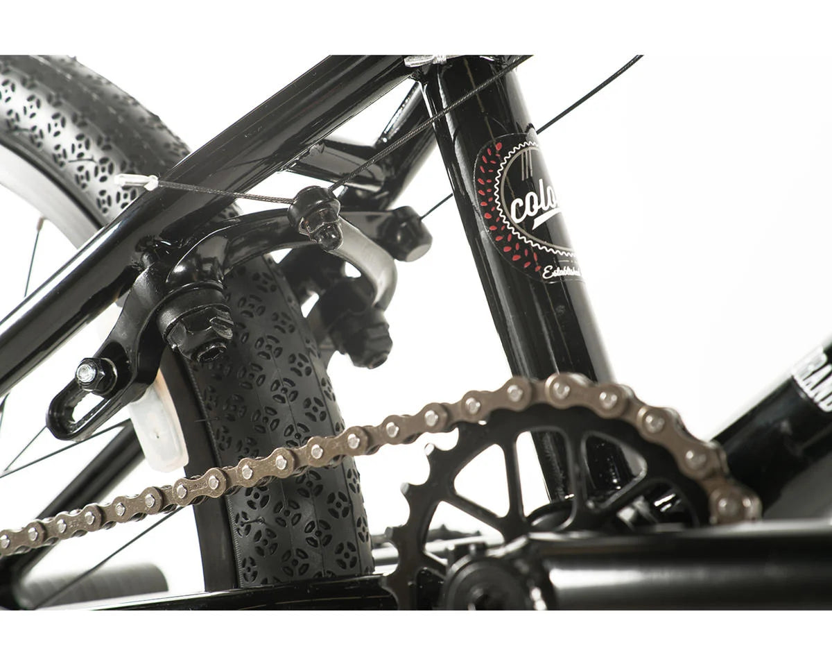 Close-up view of Colony Apprentice BMX bike showcasing the chain, brakes, and tire details.