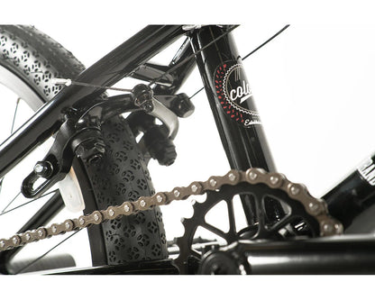 Close-up view of Colony Apprentice BMX bike showcasing the chain, brakes, and tire details.